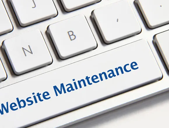 Picture of a laptop/computer keyboard and the words 'website maintenance' written on the space bar.